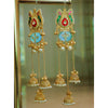 Ornate gold earrings with pearls and colorful stones on a reflective surface.
