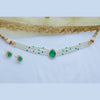Jewelry set with necklace and earrings featuring green stones on a light background