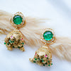 Gold earrings with green and pink gemstones on a white background