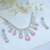 Jewelry set with pink gemstones on a light background